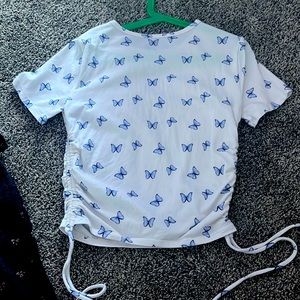 Size small kinda cropped and ties on the sides